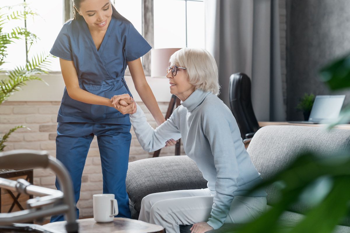 Caregiver helping senior woman