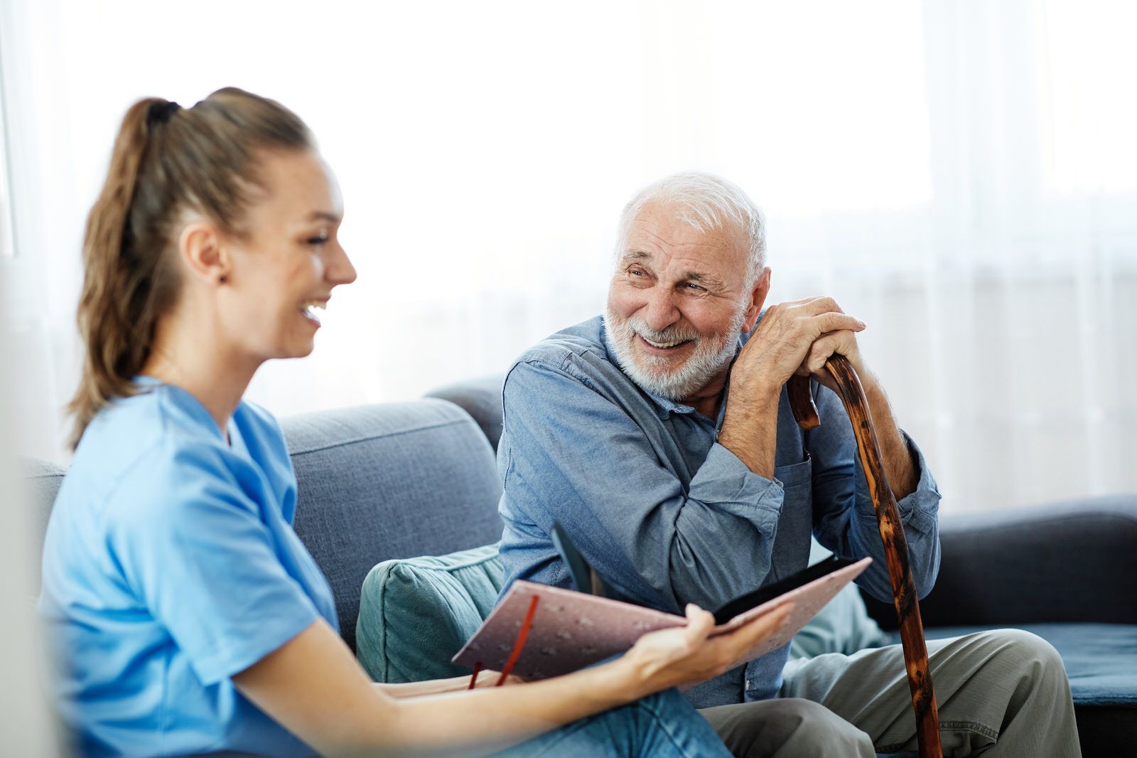 Caregiver and senior man laughing